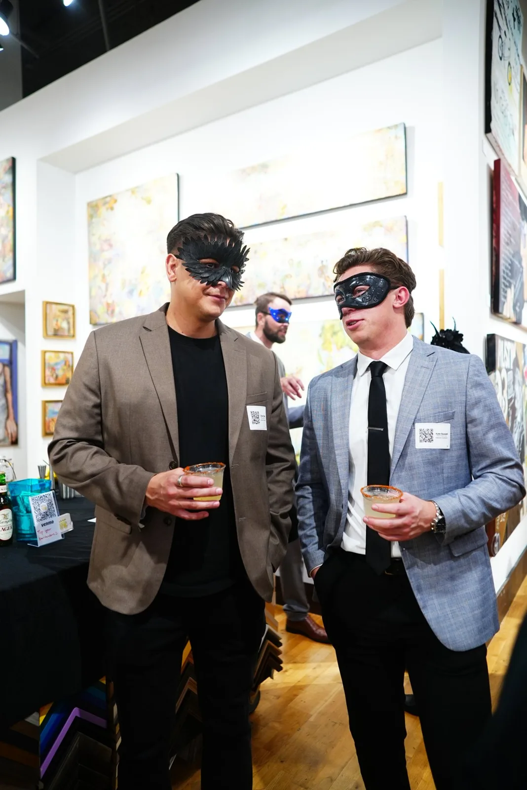 Two masked guests in conversation at Ao5 Gallery