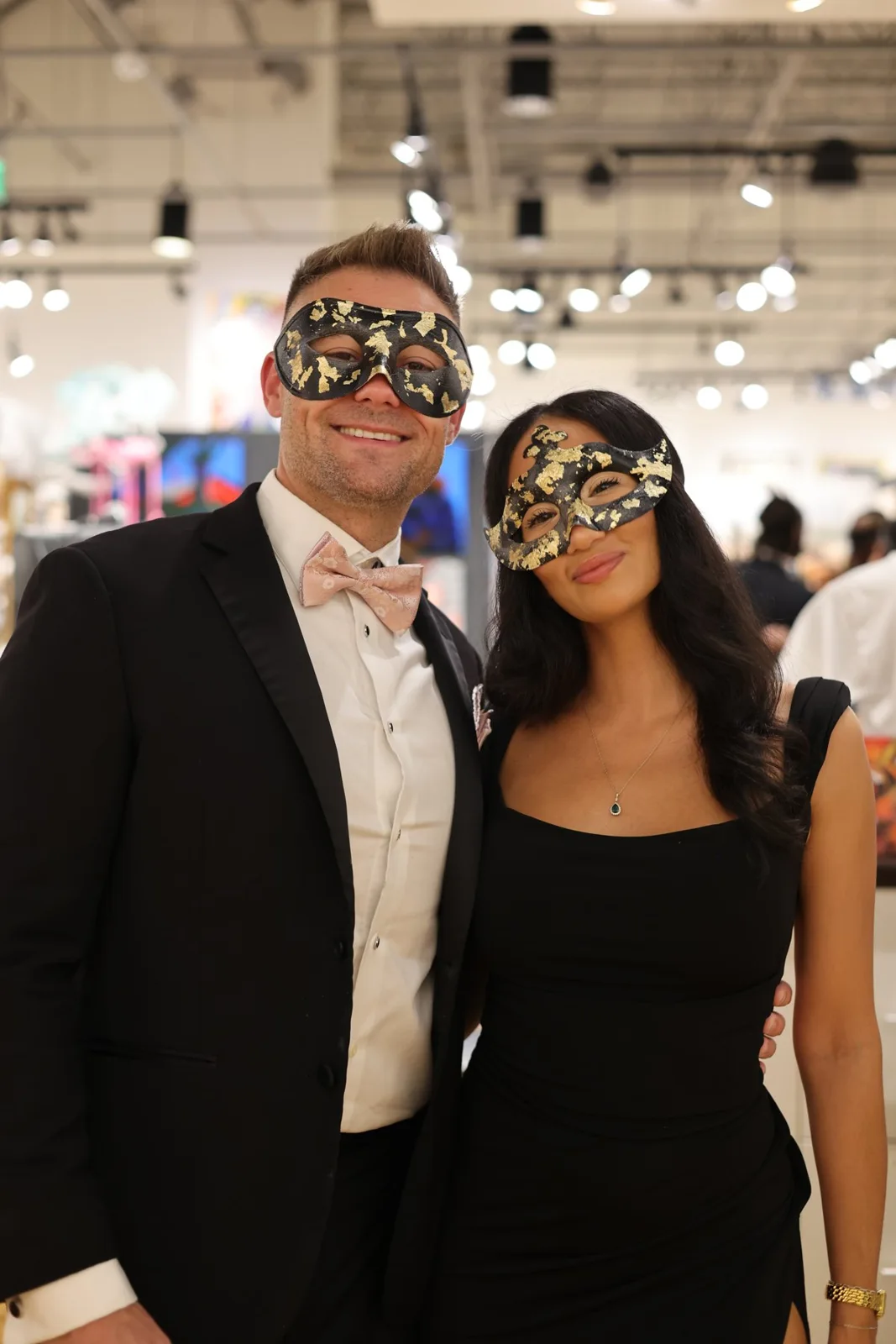 Two guests wearing masquerade masks at Ao5 Gallery
