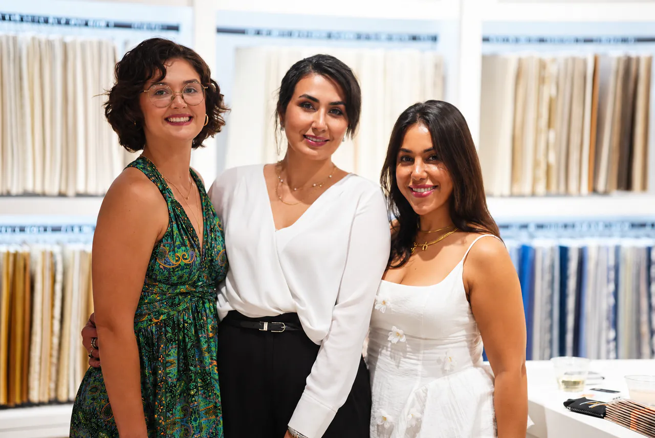 Three guests together by the fabric wall at Capitol Keys