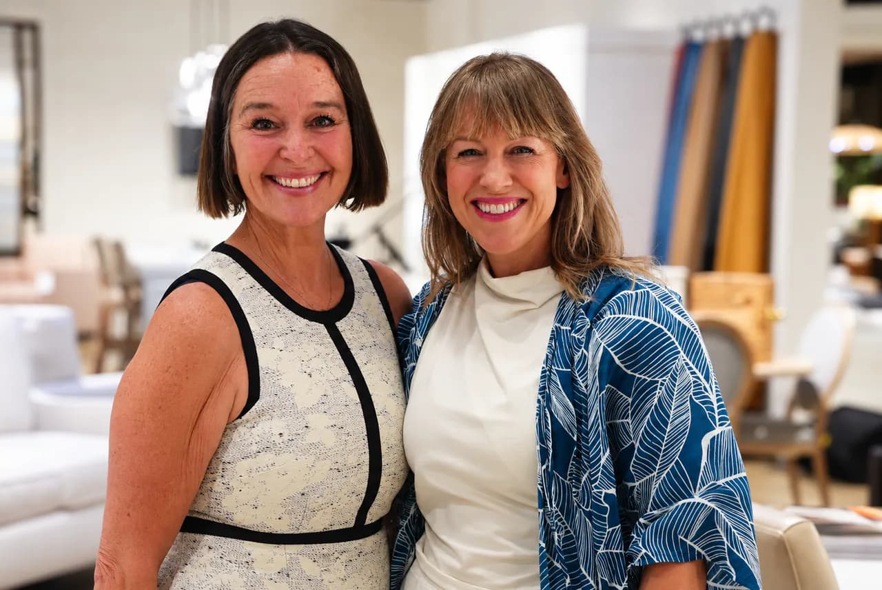 Two guests sharing a laugh on the showroom floor