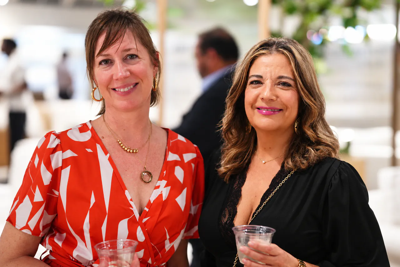 Two guests with drinks in hand at Capitol Keys